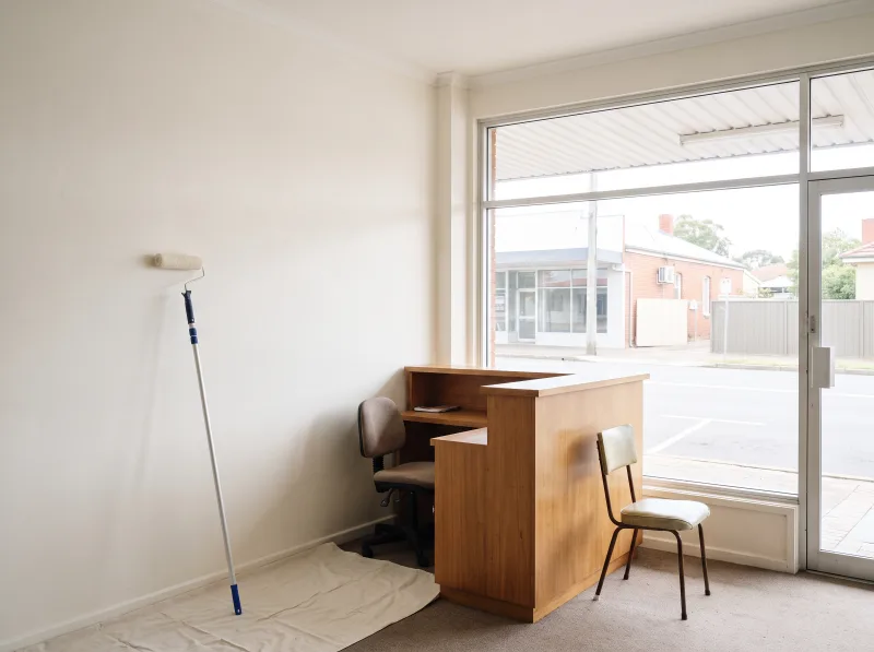 A small shopfront reception area part-way through being repainted